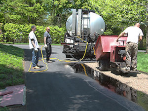 Spreading stone into asphalt cement